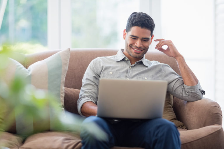 Employees want remote work. Man on a couch with a laptop