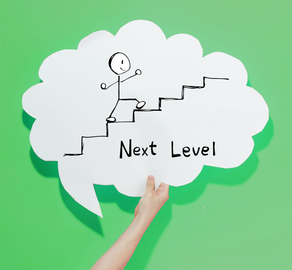 Speech bubble showing a stick person climbing stairs and reads "Next Level"
