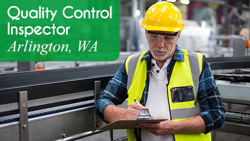 Now Hiring a Quality Control Inspector in Arlington, WA. Image shows a man wearing a safety vest and hard hat, holding a clipboard in a production environment