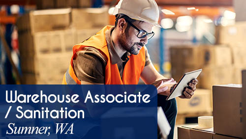 Image shows a man with boxes in a warehouse. Now Hiring a Warehouse Associate / Sanitation Worker in Sumner, WA