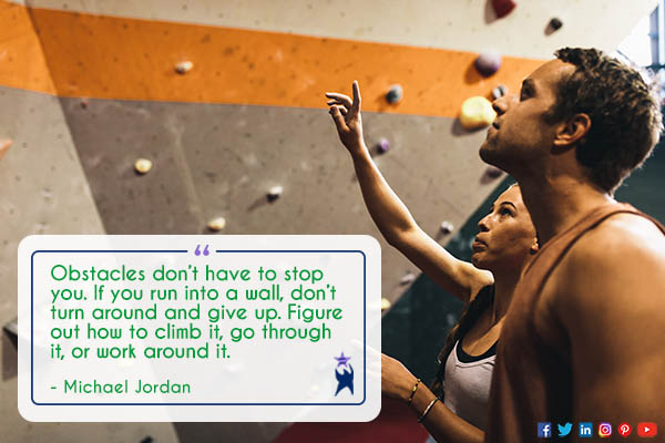 Image shows a man and a woman looking up at a climbing wall. Text reads: "Obstacles don't have to stop you. If you run into a wall, don't turn around and give up. Figure out how to climb it, go through it, or work around it." - Michael Jordan. All StarZ Staffing