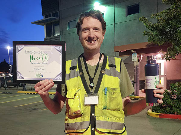 Employee of the Month for September 2023. Image shows Phillip holding the Employee of the Month certificate and water bottle.