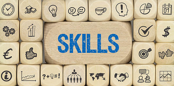 Image shows stacked wooden blocks with skills icons. At the center is a larger block with the word "SKILLS." All StarZ Staffing.