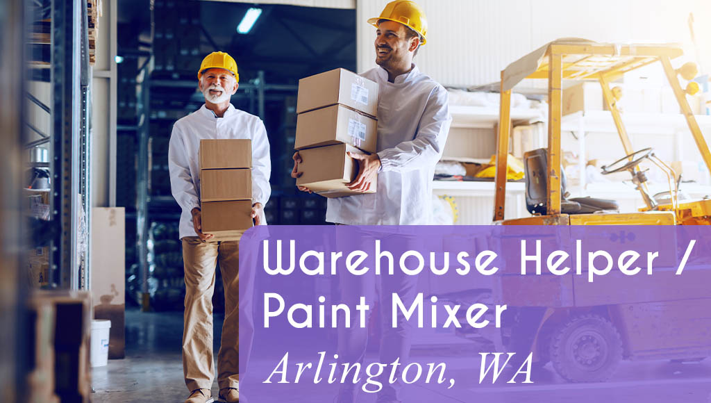 Image shows two men carrying boxes in a warehouse setting with a forklift in the background. Now Hiring a Warehouse Helper / Paint Mixer in Arlington, WA. All StarZ Staffing.