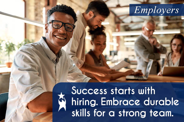 Image shows a group of professionals working together at a table in an office setting. Text reads: Employers. Success starts with hiring. Embrace durable skills for a strong team. All StarZ Staffing.